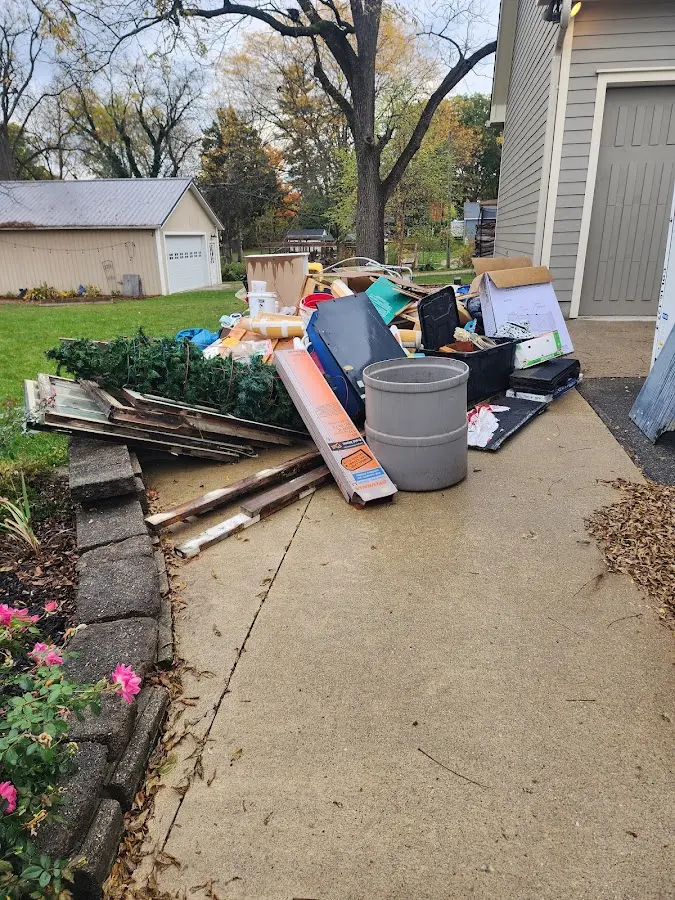 Dumpster being loaded with debris for Estate Cleanout Dumpster Rental in Lafayette